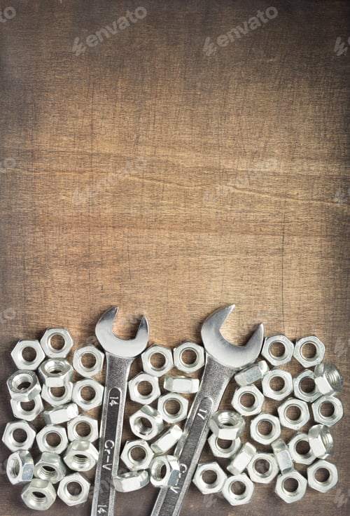 Preview: wrench tools and metal nuts at wood
