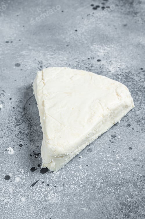 Preview: Soft goat and sheep milk cheese. Gray background. Top view