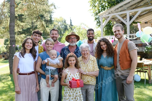Preview: Family portrait at outdoor summer garden party. Family and friends standing, posing for a group