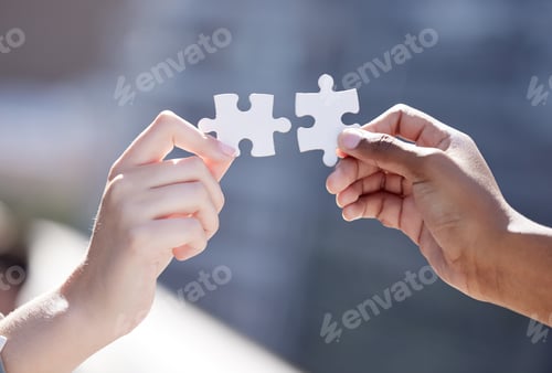 Preview: Cropped shot of two unrecognizable businessmen completing a puzzle