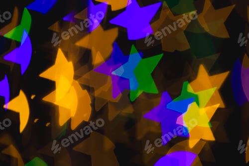 Preview: Multicoloured star bokeh lights with copy space on dark background