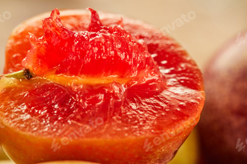 Preview: Fresh red plum, cut in half with pits, ready to eat