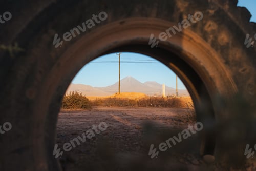 Preview: Shot of volcano through a old tire in San Pedro de Atacama, Chile
