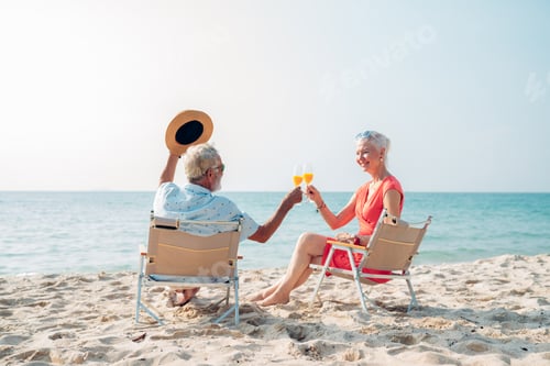 Vista previa: Happy senior couple sitting on a chair on the shore of the beach