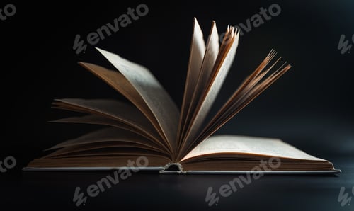 Preview: Open book with pages on a black background.