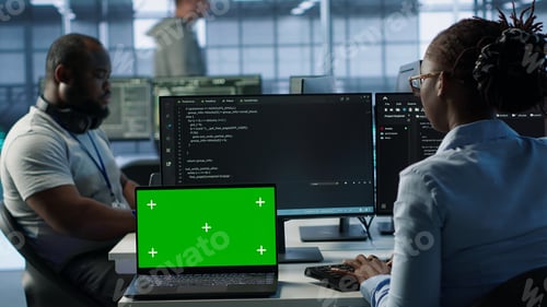 Preview: Team of developers in server hub using green screen laptop