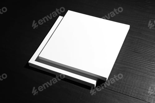 Preview: Stack of blank paper sheets for brochure on black wooden background. Mock up