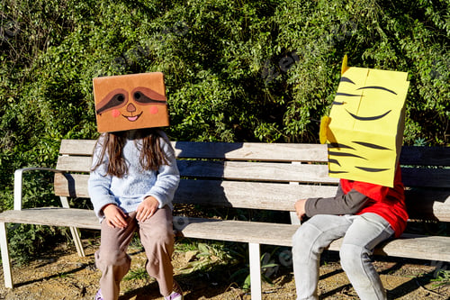 Preview: Children with heads in a cardboard box, decorated it to look like animals