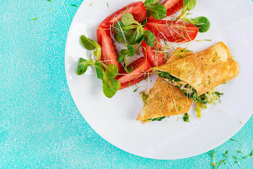 Preview: Omelette rolls on a plate. Homemade fried omelet rolls with chopped greens.