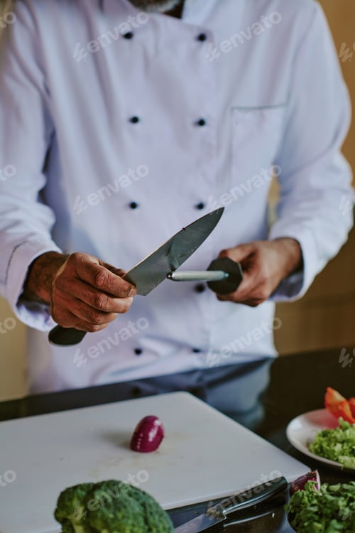 Preview: Male Chef Sharpening Knife