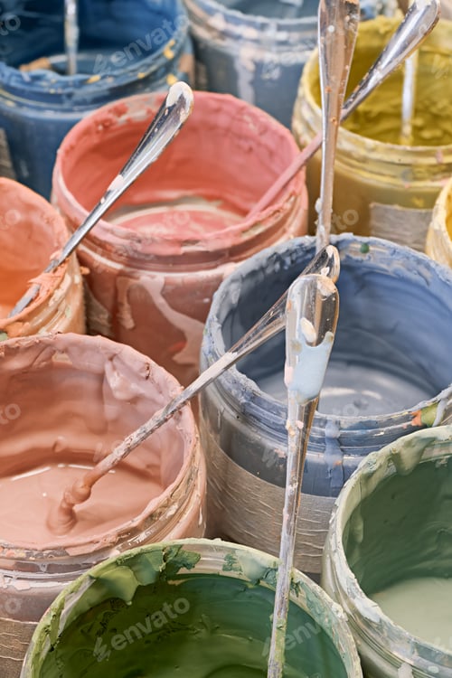 Preview: Group of open cans of multi-coloured paints