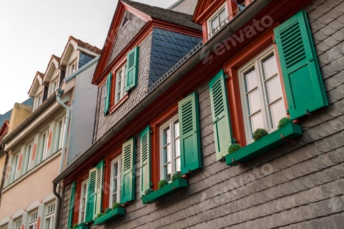 Preview: European windows with green wooden shutters in old house. Outdoors exterior