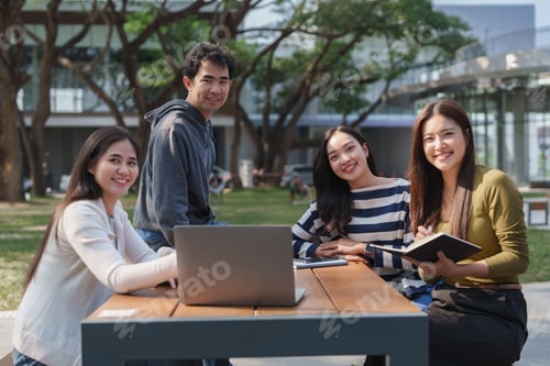 Preview: Young asian students collaborating on campus with laptop