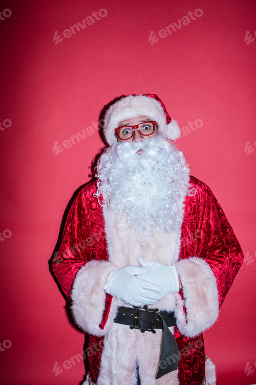 Preview: Man dressed as Santa Claus gesturing with funny glasses