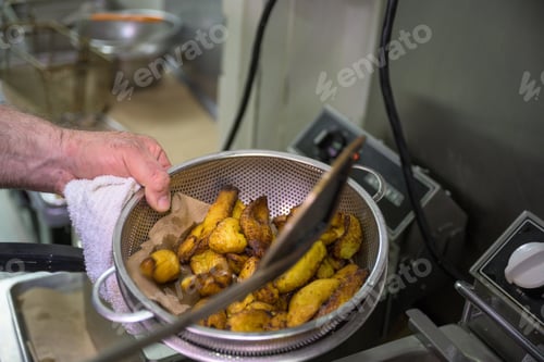 Preview: Chef making fried plantains in a restaurant kitchen, Venezuelan traditional cuisine