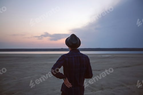 Preview: Man in hat on beach at sunset, Odessa, Ukraine