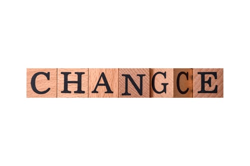 Preview: The inscription chance or change with wooden cubes on a dark concrete background