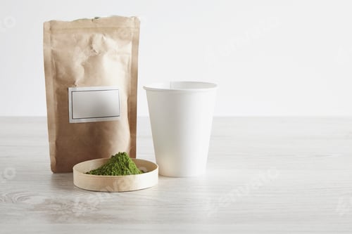 Preview: Paper bag, glass and matcha tea on white table