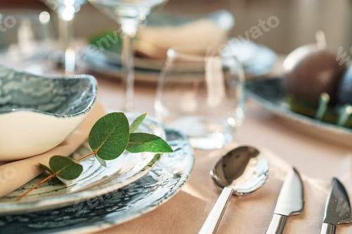 Preview: Beautiful elegant table setting with green stylish dishware and silver cutlery