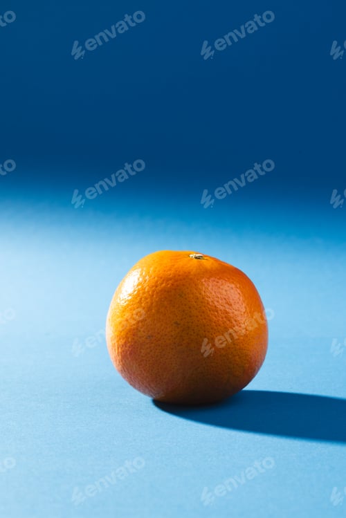 Preview: Close up of orange and copy space on blue background