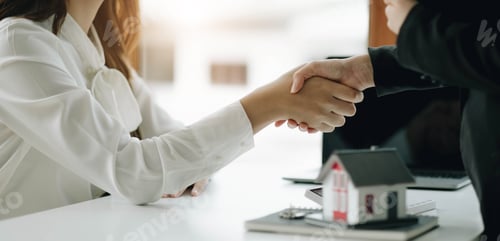 Preview: Two business people shaking hands as successful agreement in real estate agency office. Concept of
