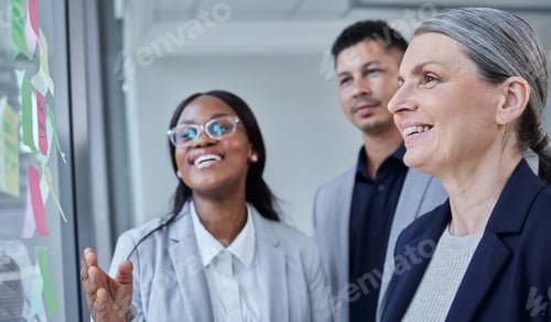 Preview: Shot of a group of businesspeople brainstorming with notes on a glass wall in an office