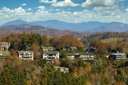 Preview: Aerial view of big family houses on mountain top between yellow trees in North Carolina