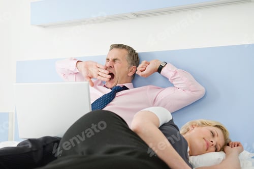 Preview: A tired business couple in bed