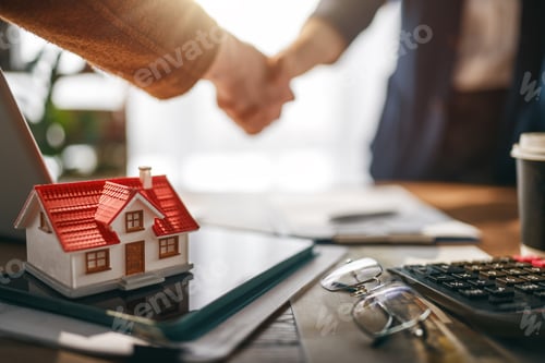 Preview: Real Estate Deal Closing Handshake with Miniature House on Office Desk, Home Purchase Agreement