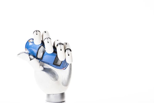 Preview: close-up view of robotic arm holding small blue car model isolated on white