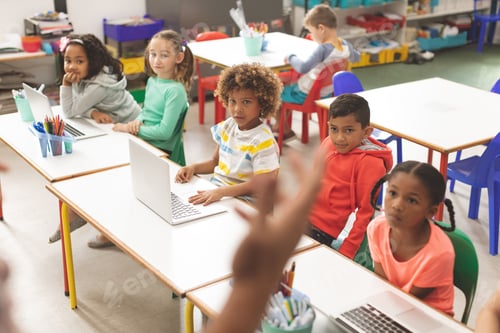 Preview: Row of school kids listening their teacher in classroom at school