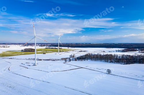 Preview: Alternative energy in Poland. Wind turbines on winter snowy field.