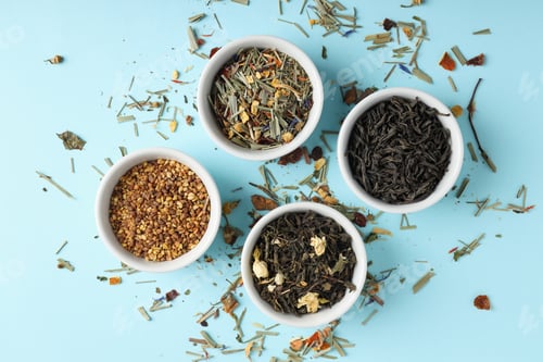 Preview: Concept of cooking tea with different types of tea on blue background