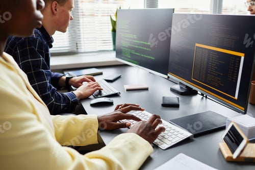 Preview: Colleagues writing codes on computers