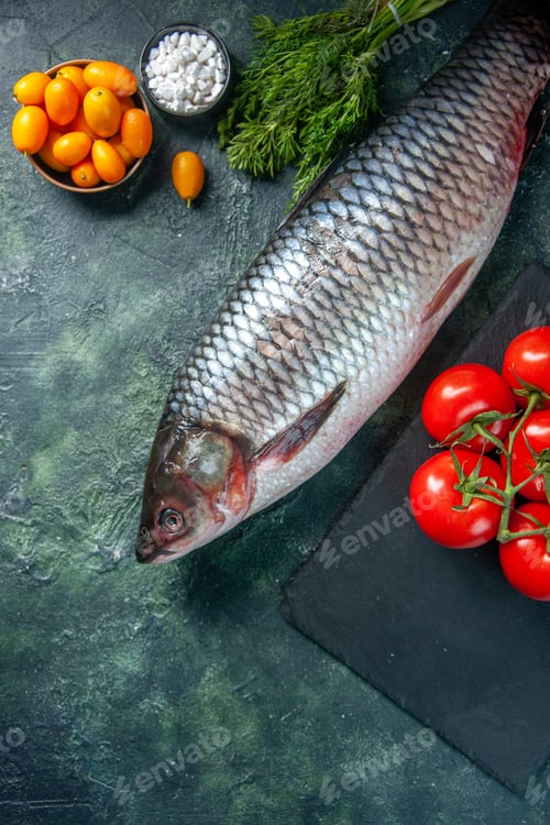 Preview: top view fresh raw fish with tomatoes and greens on dark background food health water fish color