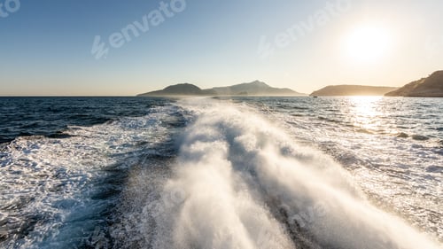 Preview: Foam in the back of a boat in seawater under sunny sunset
