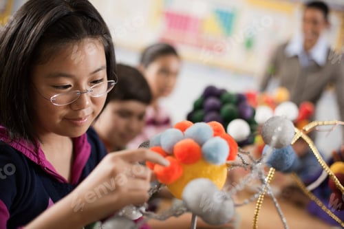 Preview: A group of students handling round shapes, making scientific models, molecular structures.
