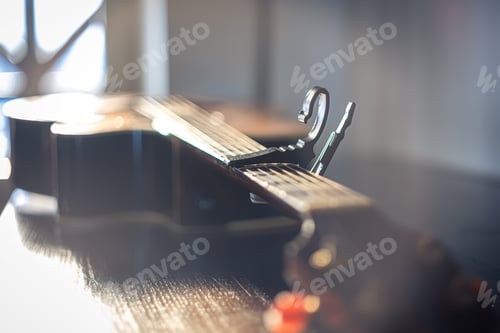 Preview: Close-up of an acoustic guitar on a blurred background.