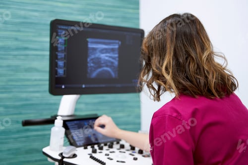 Preview: Female doctor using an ultrasound scanner in a medical center.