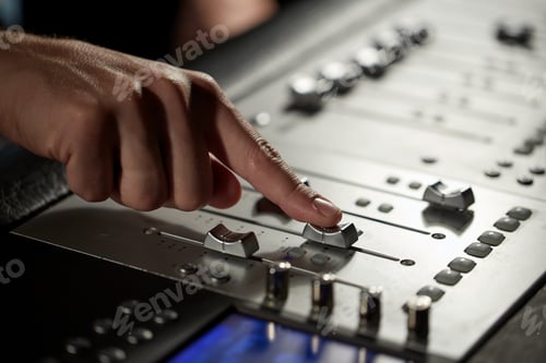Preview: hand with mixing console in music recording studio