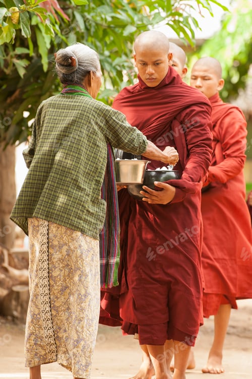 Preview: Elderly woman giving alms to a young monk