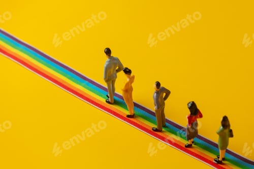Preview: Miniature Figures Standing on Rainbow Stripes on Yellow