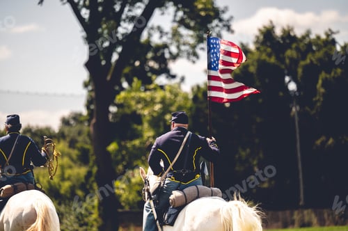 Preview: Confederate reenactor riding a horse with a flag of the United States at the Civil War reenactment