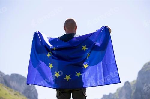 Preview: Man with EU flag over blue sky