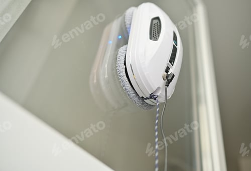 Preview: window cleaner robot cleans the dirt on the window pane.