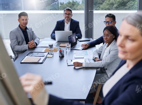 Preview: Shot of a group of businesspeople listening to a presentation in an office