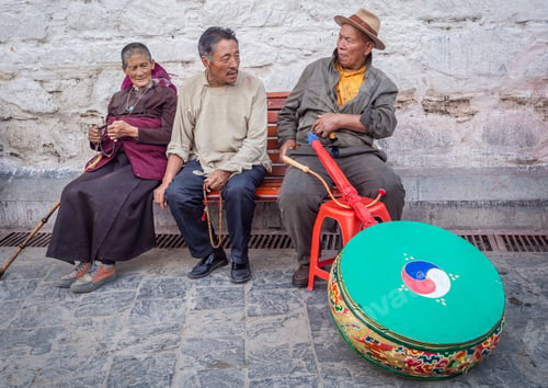 Preview: Tibet - August, 29 2014: Ethnic people sitting on street bench