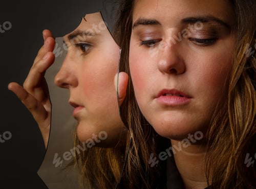 Preview: Young woman with broken piece of mirror