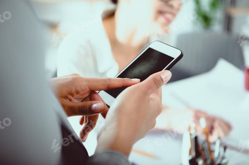 Preview: Cropped shot of businesswoman using smartphone with blank screen