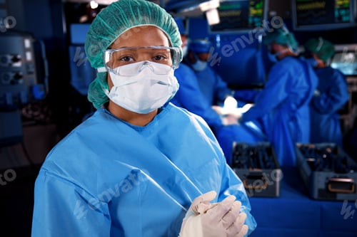 Preview: Portrait of female African American nurse wearing PPE